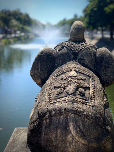 Close-up of statue against lake