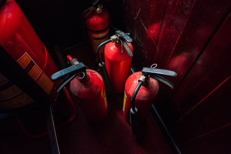 High angle view of fire extinguishers in darkroom