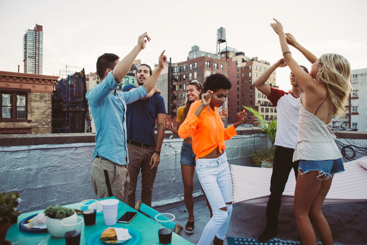 Happy friends on building terrace