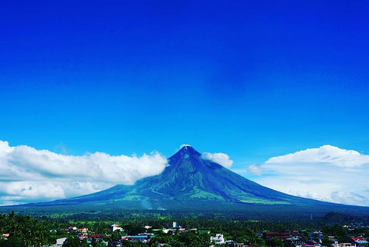 Mayon volcano against blue sky