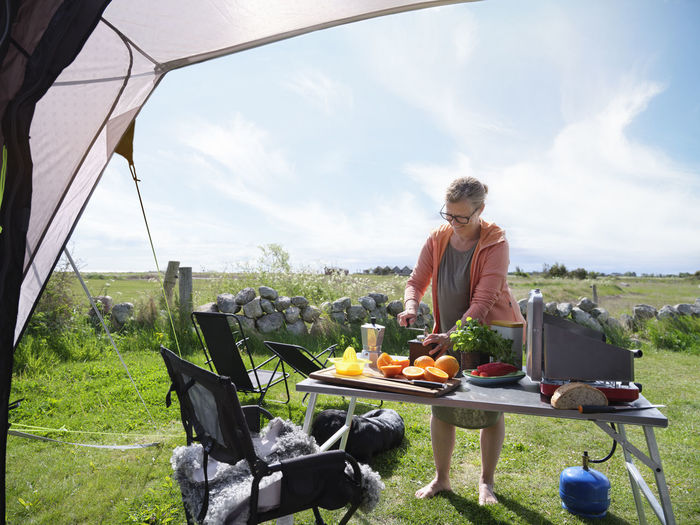 Woman preparing food in front of tent