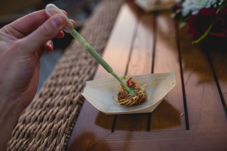 Cropped hand of woman making food