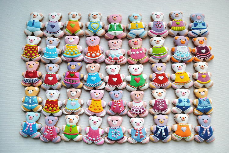 Directly above shot of colorful teddy bear shape christmas cookies on white background