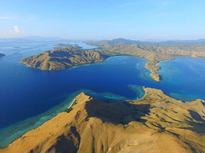 Panoramic view of sea and mountains against sky in padar island flores
