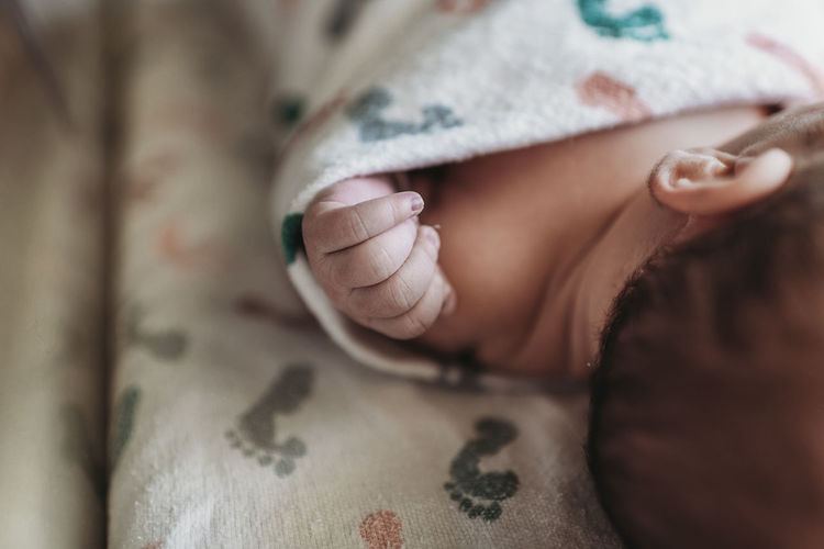 Close up detail of newborn boy hand in hospital