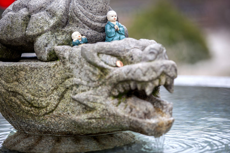 Figurines on sculpture in fountain