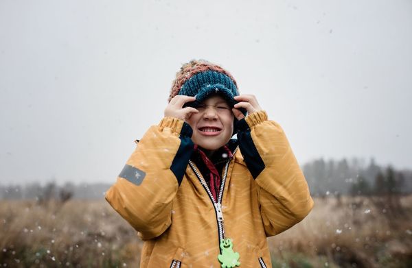 Portrait of smiling young woman standing in winter
