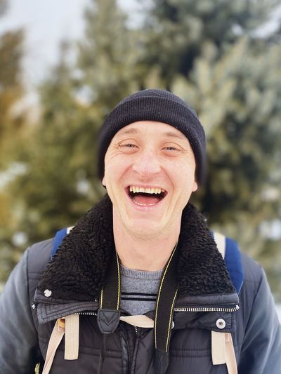 Portrait of smiling man in park during winter