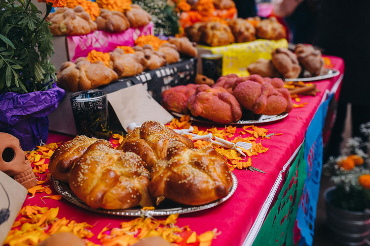 Sugar coated pan de muerto at a fair for day of the dead in roma district, mexico city, mexico