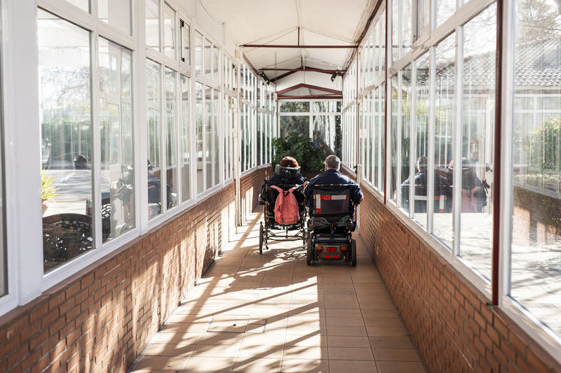 Disabled woman and man on wheelchair at rehabilitation center