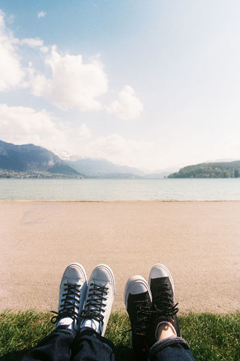 Low section of people relaxing by lake