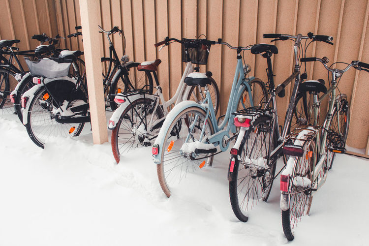 Bicycles parked on snow covered field