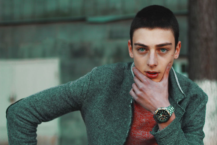 Portrait of teenage boy with hand on chin