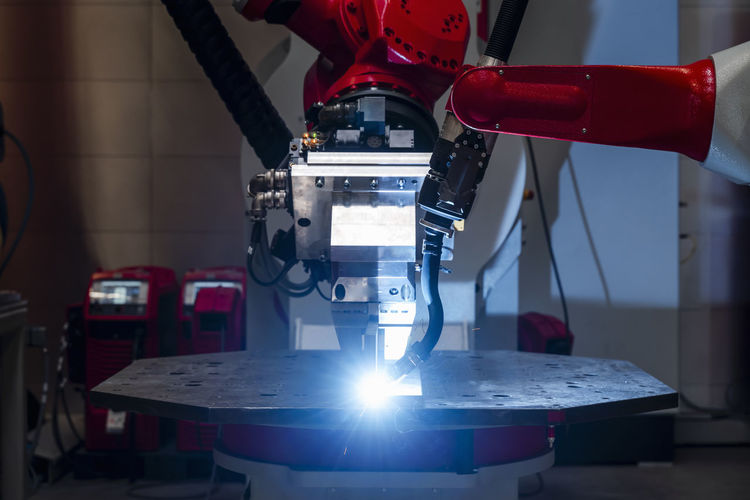 Close-up of automated robot welding metal in factory