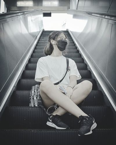 Portrait of woman sitting on staircase