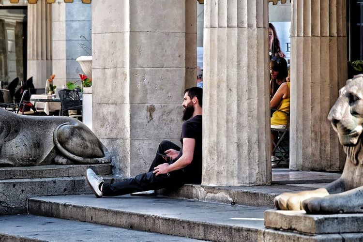 People sitting on staircase in city
