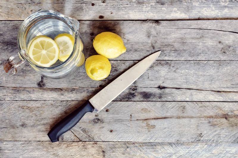 High angle view of lemons with knife