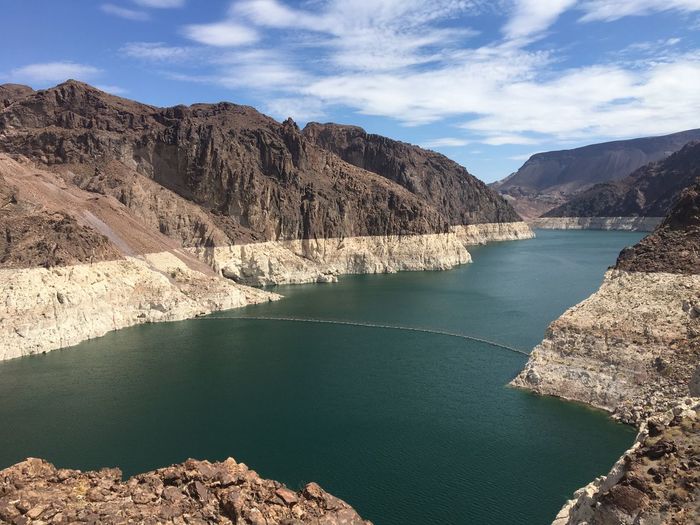 Scenic view of lake and mountains against sky at hoover dam 