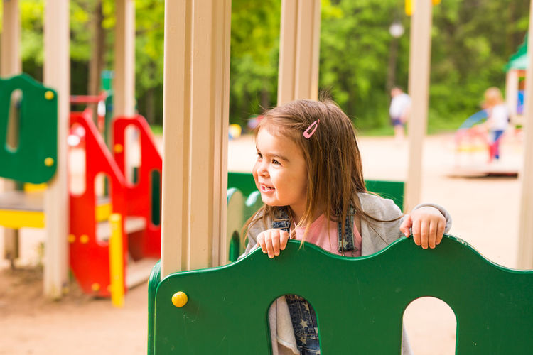 Happy girl on slide at playground