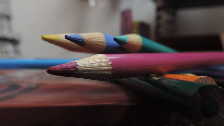 Close-up of colored pencil on table