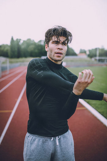 Young man practicing on running track