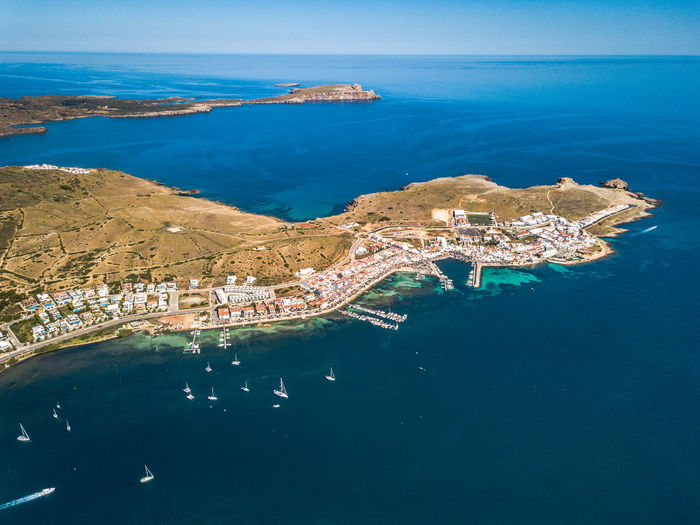 High angle view of sea and cityscape against sky