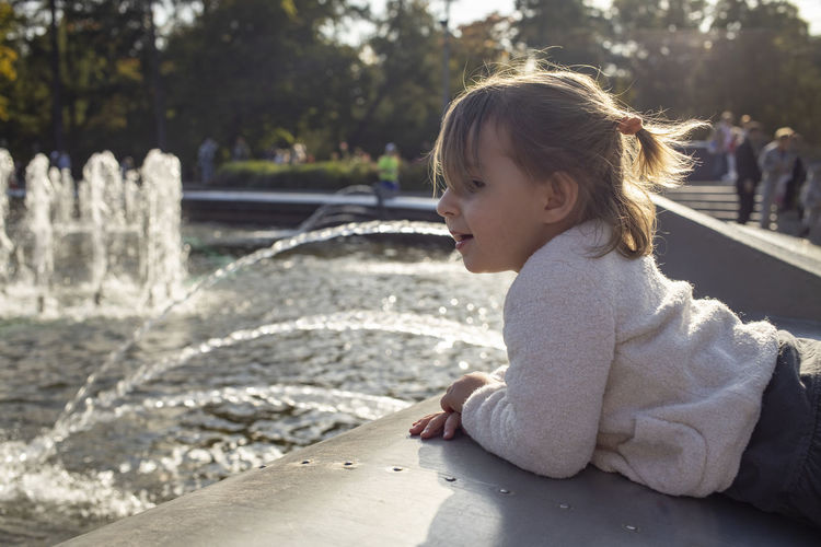 Girl enjoying near fountain outdoors