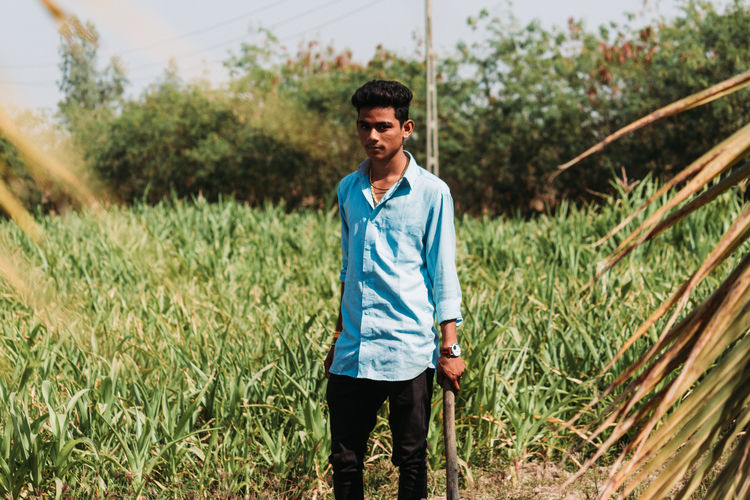 Portrait of young man standing in farm