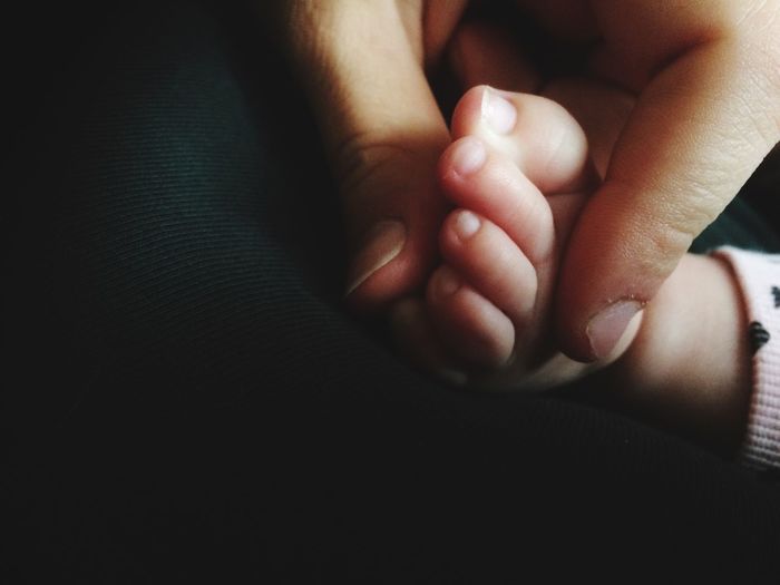 Close-up of hand holding the foot of a baby