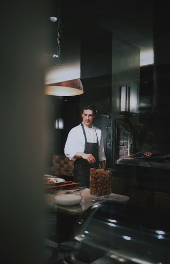 Adult Business Chef Food Food And Drink Food And Drink Industry Front View Indoors Men Occupation One Person Preparation Preparing Food Real People Restaurant Small Business Standing Table Uniform Young Adult Young Men