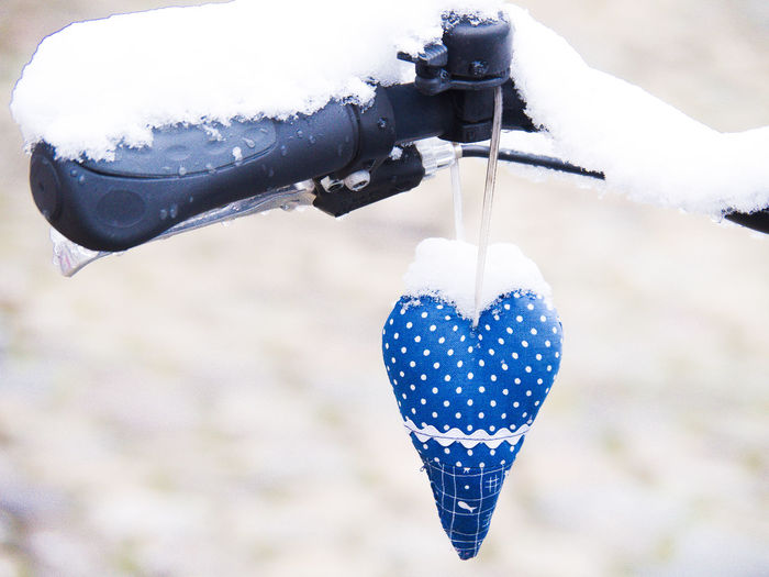 Close-up of heart shape hanging on snow