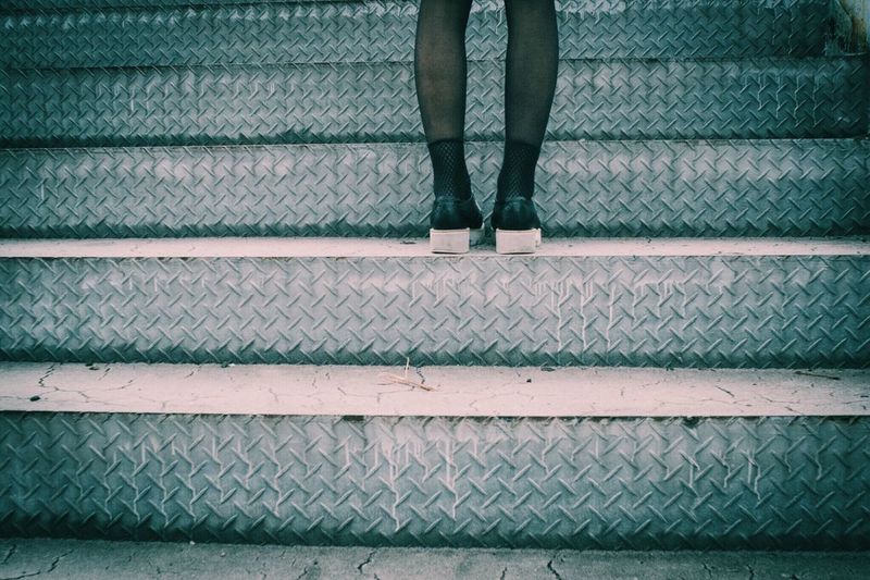 Low section of woman standing on steps