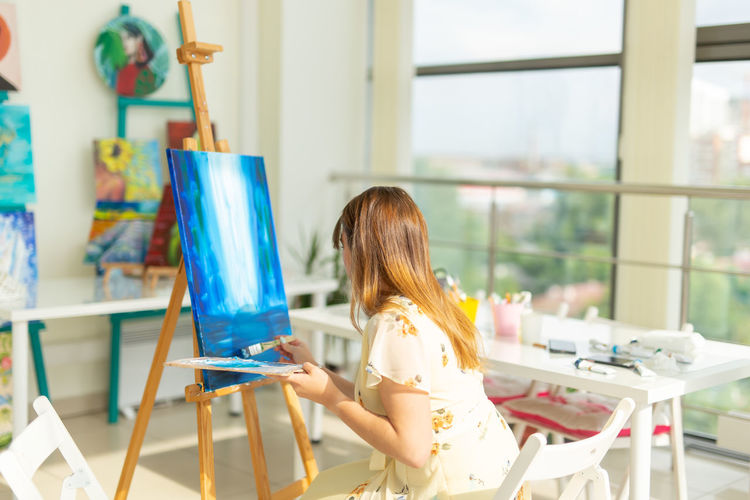 Woman sitting on chair at table