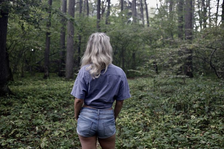 Full length of girl standing in forest