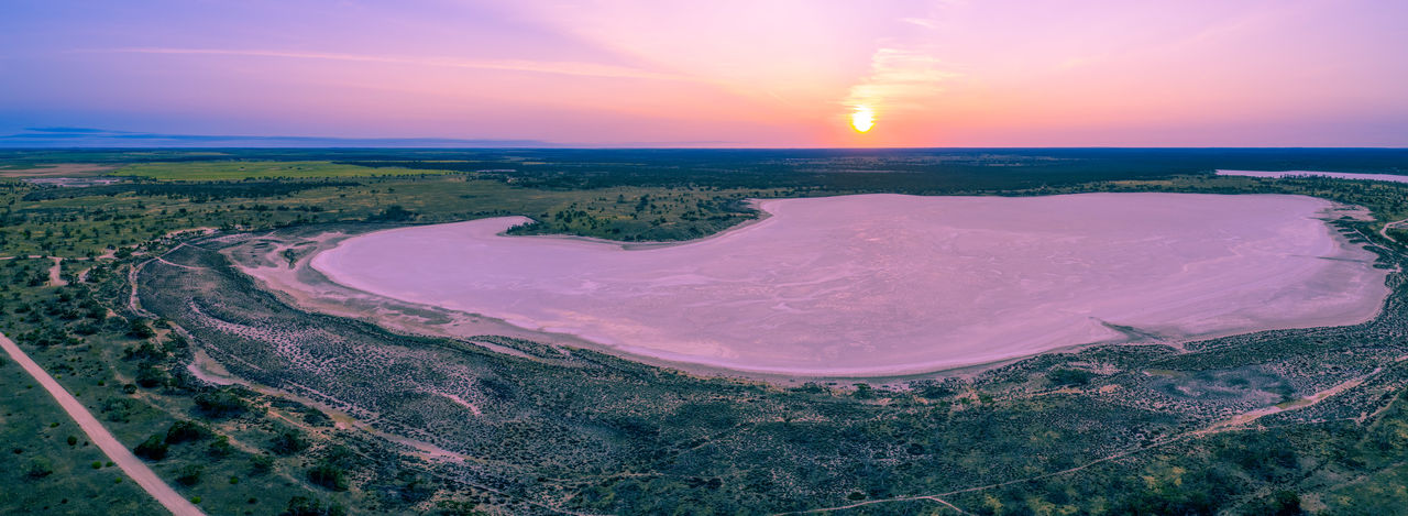 Aerial panorama of sunset over pink lake in australia