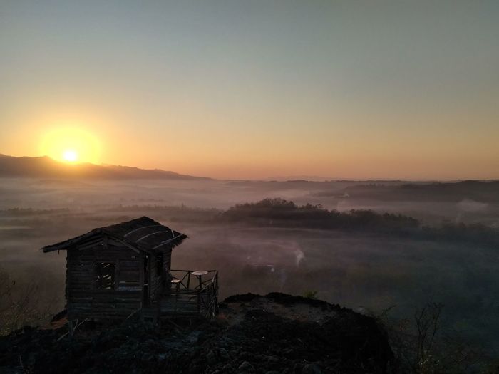 Sunrise view with a hut on the hilltop
