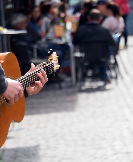 Man playing guitar in city