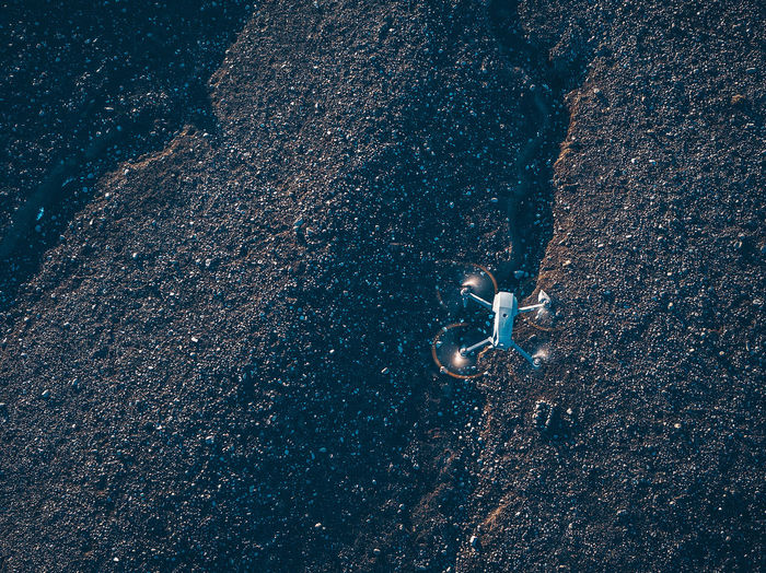 High angle view of drone flying over field