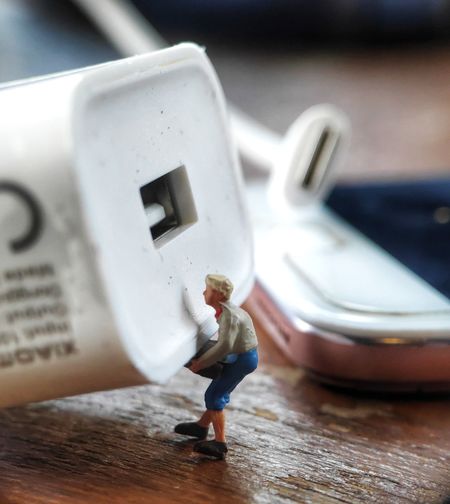 Close-up of figurine with usb on table