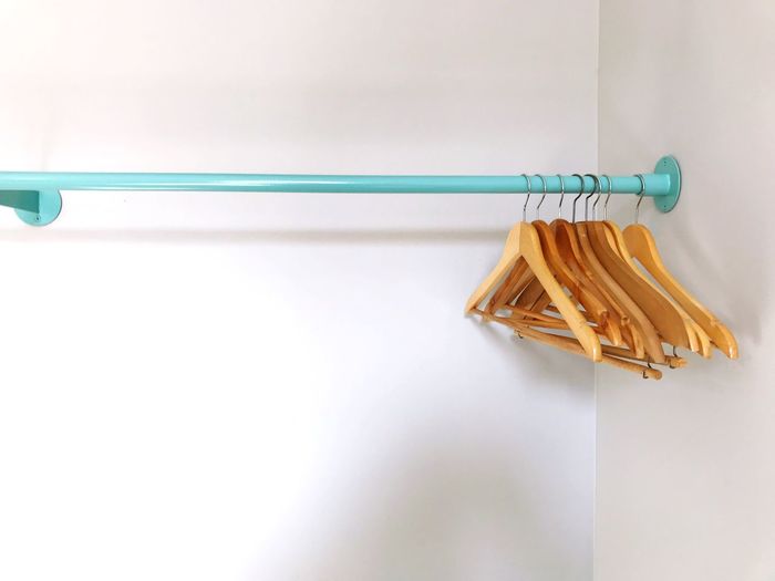 Close-up of clothes hanging on white wall