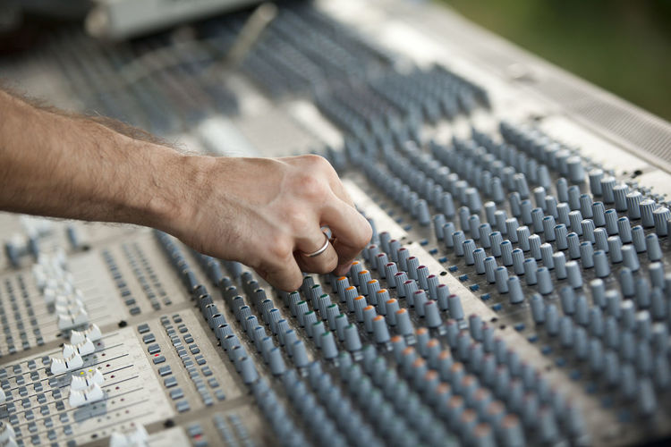 Close-up of hand using sound mixer