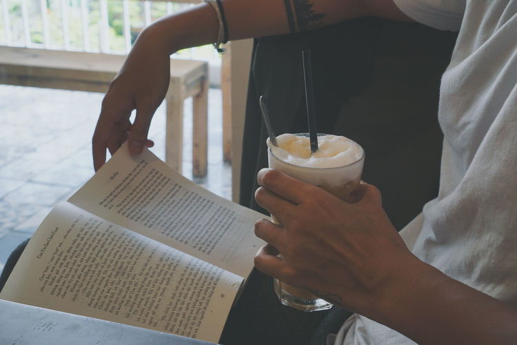 Midsection of man holding book