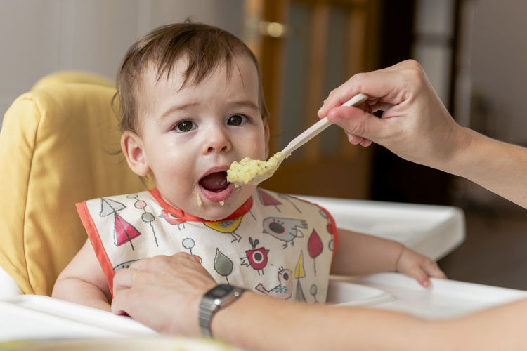 Portrait of cute boy eating baby
