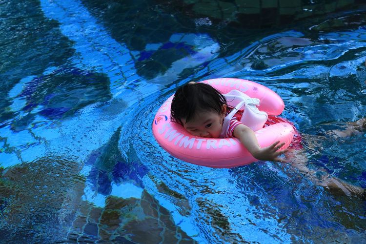 High angle view of girl swimming in pool
