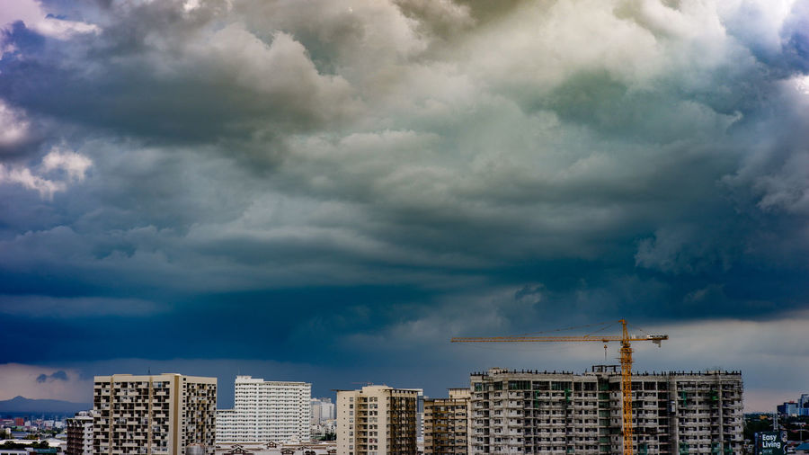 Modern buildings against cloudy sky