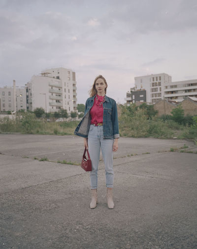 Full length portrait of woman standing in city