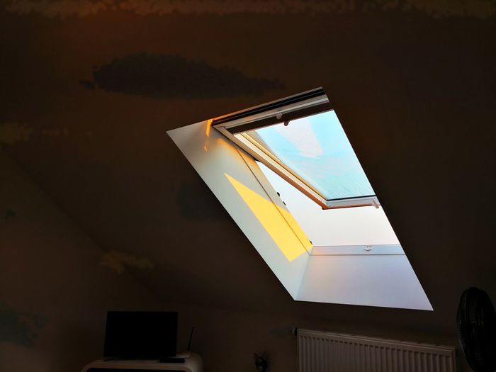 Low angle view of open ceiling window at home