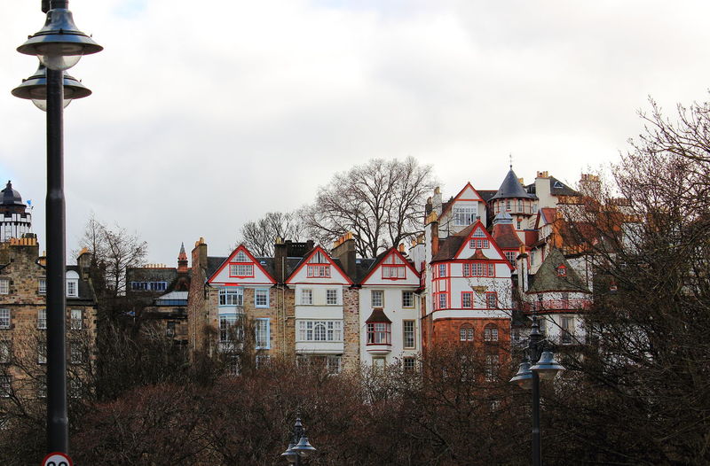 Houses and buildings against sky during winter