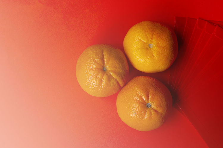 High angle view of oranges against yellow background
