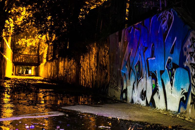 Graffiti on wall by building at night